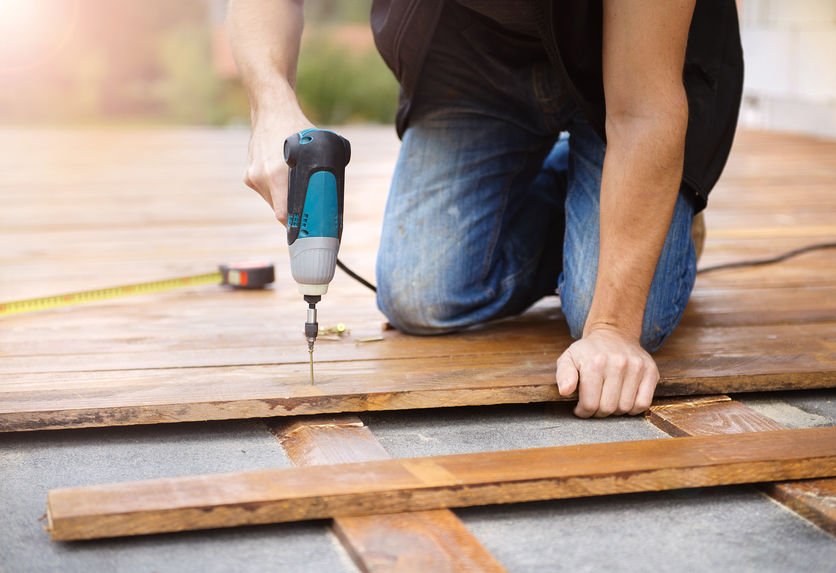 Handyman screwing into decking